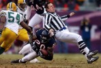 Umpire Jeff Rice gives the Green Bay Packers defense some unexpected help by stopping Chicago Bears running back Thomas Jones. (Photographer Rob Sumner)