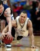 The University of Washington's Brandon Roy dives for a loose ball against Utah State in the NCAA Men's Basketball Tournament at Cox Arena in San Diego. (Photographer: Scott Eklund)