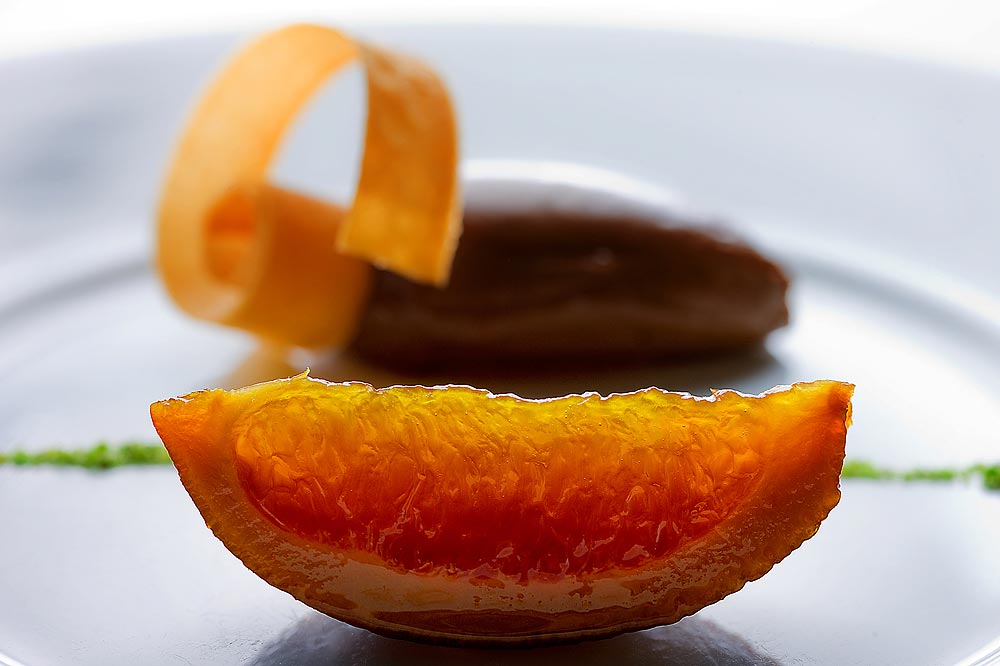 Orange confit with chocolate caramel mousse and ground pistachio at Lampreia Restaurant in Seattle. (Photographer: Scott Eklund)