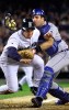Raul Ibanez scores despite a collision with Jorge Fabregas at home plate. (Photographer: Andy Rogers)