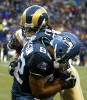 Seahawks wide receiver Darrell Jackson can't hold on to the ball as he gets drilled by Rams defender Corey Chavous. (Photographer: Scott Eklund)